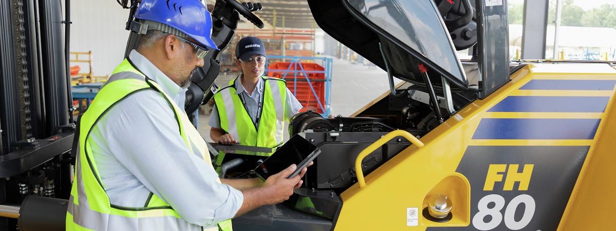 Service tech working on a forklift